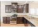 Kitchen with dark brown cabinets, granite countertops, and stainless steel appliances at 9510 Birkwood Ct, Charlotte, NC 28278