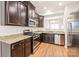 Modern kitchen with dark wood cabinets and granite countertops at 9510 Birkwood Ct, Charlotte, NC 28278