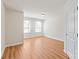 Bright bedroom featuring two windows and laminate flooring at 9510 Birkwood Ct, Charlotte, NC 28278