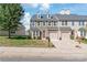 Two story townhome with stone exterior, two car garage, and landscaping at 9510 Birkwood Ct, Charlotte, NC 28278