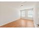 Bright bedroom with wood flooring and two windows at 9510 Birkwood Ct, Charlotte, NC 28278