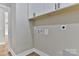 Functional laundry room with upper cabinets and hookups at 3207 Frazier Dr, Claremont, NC 28610