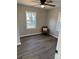 Bright bedroom featuring wood-look flooring and a window with natural light at 113 Dellinger Rd, Shelby, NC 28152