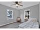 Bright bedroom with two windows, ceiling fan, and hardwood floors at 113 Dellinger Rd, Shelby, NC 28152