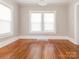 Spacious dining room featuring hardwood floors and large windows at 1411 Lineberger Ave, Gastonia, NC 28052