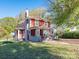 Charming two-story red house with a green lawn at 1411 Lineberger Ave, Gastonia, NC 28052