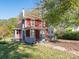 Charming two-story red house with a green lawn at 1411 Lineberger Ave, Gastonia, NC 28052