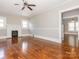 Bright living room with hardwood floors, fireplace, and ceiling fan at 1411 Lineberger Ave, Gastonia, NC 28052