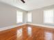 Spacious bedroom with hardwood floors and multiple windows at 1411 Lineberger Ave, Gastonia, NC 28052