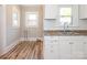 Bright kitchen features white cabinets, new flooring, and a classic subway tile backsplash at 1411 Lineberger Ave, Gastonia, NC 28052