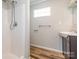 Updated bathroom with a shower, vanity, and wood-look flooring at 1411 Lineberger Ave, Gastonia, NC 28052