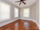 Bright bedroom with hardwood floors, ceiling fan, and two windows at 1411 Lineberger Ave, Gastonia, NC 28052