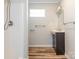 Clean bathroom with a shower, vanity, and wood-look flooring at 1411 Lineberger Ave, Gastonia, NC 28052