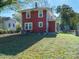 Rear view of red house with yard and AC unit at 1411 Lineberger Ave, Gastonia, NC 28052