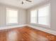 Well-lit bedroom featuring hardwood floors and two windows at 1411 Lineberger Ave, Gastonia, NC 28052