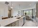 Modern kitchen island with sink, dishwasher and seating area, open to dining area at 3244 Stelfox St, Charlotte, NC 28262
