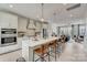 Modern kitchen with island, stainless steel appliances, and open living space at 3244 Stelfox St, Charlotte, NC 28262