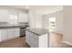 Eat-in kitchen with white cabinets, granite countertops, and breakfast bar at 3507 Clover Valley Dr, Gastonia, NC 28052