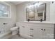 Modern bathroom with white vanity, double sinks, and large mirror at 3865 Highway 200 Hwy, Concord, NC 28025