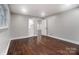 Well-lit bedroom with dark hardwood floors and access to bathroom at 3865 Highway 200 Hwy, Concord, NC 28025