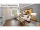 Living room with gray walls, hardwood floors, and large windows at 6012 Sylvan Dr, Denver, NC 28037