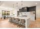 Modern kitchen with white cabinetry, large island, quartz countertops and gold accents at 1017 Maxwell Ct # 5, Marvin, NC 28173