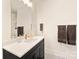 Contemporary bathroom with dark vanity and geometric tile floor at 1017 Maxwell Ct # 5, Marvin, NC 28173
