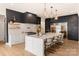 Modern kitchen with white and dark cabinetry, quartz countertops and gold accents at 1017 Maxwell Ct # 5, Marvin, NC 28173