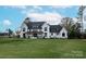 Stunning two-story home with a white exterior, gray roof and a spacious lawn at 1017 Maxwell Ct # 5, Marvin, NC 28173