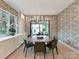 Elegant dining room featuring a round table, stylish chairs, and wallpaper at 1401 Heather Ln, Charlotte, NC 28209