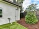 Side yard with shed, landscaping, and artificial turf at 1401 Heather Ln, Charlotte, NC 28209