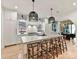 Modern kitchen with white cabinets, large island, and pendant lighting at 1401 Heather Ln, Charlotte, NC 28209