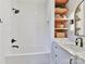 Modern bathroom with white subway tile and built-in shelves at 1401 Heather Ln, Charlotte, NC 28209