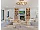Spacious living room featuring a fireplace, built-in shelving and large windows at 1401 Heather Ln, Charlotte, NC 28209