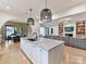 Open kitchen showcasing a large island, breakfast area, and Gathering room at 1401 Heather Ln, Charlotte, NC 28209