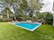 Inviting swimming pool with surrounding landscaping and lounge chairs at 1401 Heather Ln, Charlotte, NC 28209