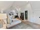 Bright bedroom with a king-size bed, ensuite bathroom access, and a home gym at 1401 Heather Ln, Charlotte, NC 28209