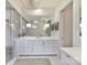 Spa-like bathroom with a large vanity, walk-in shower, and elegant chandelier at 1401 Heather Ln, Charlotte, NC 28209