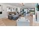 Open concept living room with a large sectional sofa and sliding doors to backyard at 1401 Heather Ln, Charlotte, NC 28209