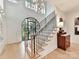 Two-story entryway with a stunning staircase and natural light at 1401 Heather Ln, Charlotte, NC 28209