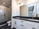 Modern bathroom with double vanity, large mirror, and glass shower at 1512 Levy Way, Charlotte, NC 28205