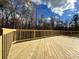 New deck with wooden railings and wooded backdrop at 2387 Trundle Dr # Cwo0155, Gastonia, NC 28054