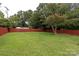 Fenced backyard offering a large grassy area and mature trees at 4921 Elder Ave, Charlotte, NC 28205