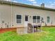 Small patio area with table and chairs, leading to a grassy yard at 8509 Loxton Cir, Charlotte, NC 28214