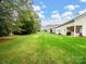 Spacious backyard with green lawn and mature trees at 8509 Loxton Cir, Charlotte, NC 28214