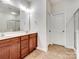 Double vanity bathroom with a large mirror and plenty of storage at 8509 Loxton Cir, Charlotte, NC 28214