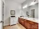 Double vanity bathroom with updated wood cabinets and flooring at 8509 Loxton Cir, Charlotte, NC 28214