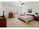 Main bedroom with carpeted floors and a large bed at 8509 Loxton Cir, Charlotte, NC 28214