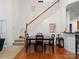 Bright dining area with a wooden table and chairs near staircase at 8509 Loxton Cir, Charlotte, NC 28214