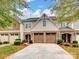 Brick front two-story townhome with a two-car garage and landscaping at 8509 Loxton Cir, Charlotte, NC 28214